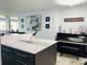 Kitchen island with seating, with a piano in the background at 5200 Brittany S Dr # 204, St Petersburg, FL 33715