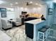Bright kitchen with sleek white cabinetry, a modern island with seating, and stainless steel appliances at 5200 Brittany S Dr # 204, St Petersburg, FL 33715