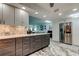 Open kitchen with stainless appliances, gray drawers, white counter tops and a refrigerator at 5200 Brittany S Dr # 204, St Petersburg, FL 33715