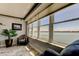 Bright living room with large windows offering panoramic water views and comfortable seating at 5200 Brittany S Dr # 204, St Petersburg, FL 33715