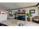 Open-concept living room with a large television, modern decor, and stylish seating area at 5200 Brittany S Dr # 204, St Petersburg, FL 33715