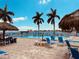 Inviting pool area with waterfront views, palm trees, and comfortable lounge chairs, ideal for relaxation and entertainment at 5200 Brittany S Dr # 204, St Petersburg, FL 33715
