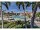 Relaxing community pool surrounded by mature tropical landscaping and comfortable lounge chairs at 5200 Brittany S Dr # 204, St Petersburg, FL 33715