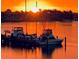 Stunning sunset view over the water with boats docked, creating a picturesque and peaceful waterfront scene at 5200 Brittany S Dr # 204, St Petersburg, FL 33715