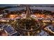 Stunning aerial view of the town featuring a roundabout and lit-up streets at night at 5340 Royal Palm Ave # 5340, Sarasota, FL 34234