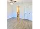 Bright bedroom with tile flooring and multiple closet doors showcases a view into a well-lit bathroom at 5340 Royal Palm Ave # 5340, Sarasota, FL 34234