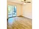 Bright bedroom with neutral walls, tile flooring, ceiling fan, and sliding glass doors to sun room at 5340 Royal Palm Ave # 5340, Sarasota, FL 34234