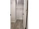 Walk-in closet with wood-look tile flooring, white walls and shelving at 5340 Royal Palm Ave # 5340, Sarasota, FL 34234