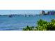 Picturesque waterfront scene with boats sailing on the tranquil waters and city buildings on the horizon at 5340 Royal Palm Ave # 5340, Sarasota, FL 34234