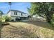 Sprawling backyard with mature trees, partial fence, and lawn at 5410 Treig Ln, Wesley Chapel, FL 33545