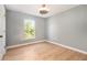 Neutral bedroom with light wood floors and natural light at 5410 Treig Ln, Wesley Chapel, FL 33545