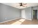 Bedroom featuring wood-look flooring, closet, and overhead fan at 5410 Treig Ln, Wesley Chapel, FL 33545