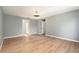 Large bedroom with multiple doors and laminate wood floors at 5410 Treig Ln, Wesley Chapel, FL 33545
