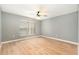 Bright bedroom featuring wood-look flooring, fan, and window at 5410 Treig Ln, Wesley Chapel, FL 33545