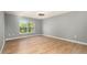 Spacious bedroom with laminate wood floors and a large window at 5410 Treig Ln, Wesley Chapel, FL 33545