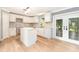 Bright kitchen featuring white cabinets, marble backsplash, a center island, and stainless appliances at 5410 Treig Ln, Wesley Chapel, FL 33545