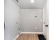 Laundry room with a door and laminate floors at 5410 Treig Ln, Wesley Chapel, FL 33545