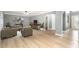 Cozy living room featuring wood floors, neutral walls, comfortable furnishings, and ample natural light at 5410 Treig Ln, Wesley Chapel, FL 33545