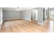 Spacious living room featuring wood floors, neutral walls, base molding, and ample natural light at 5410 Treig Ln, Wesley Chapel, FL 33545