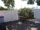 A partially shaded backyard area featuring a privacy fence and decorative tree at 5413 S Martin Ave, Tampa, FL 33611