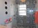 Bathroom featuring modern tile shower with glass enclosure and decorative elements at 5413 S Martin Ave, Tampa, FL 33611