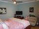 Bedroom featuring a ceiling fan, television and artistic details at 5413 S Martin Ave, Tampa, FL 33611