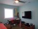 Bedroom with a tropical themed desk area, flamingo decor, and ceiling fan at 5413 S Martin Ave, Tampa, FL 33611