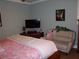 Comfortable bedroom features a ceiling fan, television, and artistic details at 5413 S Martin Ave, Tampa, FL 33611