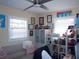 Comfortable bedroom featuring a couch, shelving, and two bright windows at 5413 S Martin Ave, Tampa, FL 33611