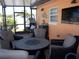 Inviting, screened-in patio featuring wicker chairs, a ceiling fan, and a comfortable hanging chair at 5413 S Martin Ave, Tampa, FL 33611