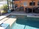 Screened-in pool and patio area with outdoor seating and dining at 5413 S Martin Ave, Tampa, FL 33611