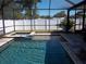 Inviting screened-in pool and spa area with a clear view of the privacy fence and the blue sky above at 5413 S Martin Ave, Tampa, FL 33611