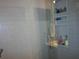 Modern bathroom shower featuring tiled walls and built-in shelving for toiletries at 5413 S Martin Ave, Tampa, FL 33611