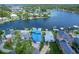 Aerial view showcasing the waterfront property with boat dock and surrounding waterways at 5449 Manatee Point Dr, New Port Richey, FL 34652
