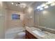 Well-lit bathroom featuring a soaking tub, granite countertop vanity, and large mirror at 5449 Manatee Point Dr, New Port Richey, FL 34652