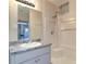 Clean bathroom with tub/shower combination, granite vanity and tile walls at 5449 Manatee Point Dr, New Port Richey, FL 34652