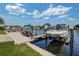 Private dock showcasing boat lifts and scenic water views on a bright, sunny day at 5449 Manatee Point Dr, New Port Richey, FL 34652
