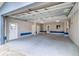 Spacious garage with ample storage, multiple entry doors and neutral paint scheme at 5449 Manatee Point Dr, New Port Richey, FL 34652