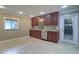 Bright kitchen featuring recessed lighting, wood cabinets, granite countertops, tile flooring, and stainless steel appliances at 5449 Manatee Point Dr, New Port Richey, FL 34652