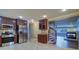 Kitchen featuring stainless steel appliances, wood cabinets, granite counters, and an open view of the living area at 5449 Manatee Point Dr, New Port Richey, FL 34652