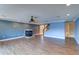 Large living room with hardwood floors, recessed lighting, a ceiling fan, and a modern fireplace at 5449 Manatee Point Dr, New Port Richey, FL 34652