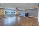 Large living room featuring hardwood floors, a modern fireplace, recessed lighting, and waterfront views at 5449 Manatee Point Dr, New Port Richey, FL 34652