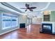 Spacious living room boasts hardwood floors, fireplace, water view and tray ceiling with fan at 5449 Manatee Point Dr, New Port Richey, FL 34652