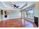 Living room featuring hardwood floors, fireplace, and abundant natural light from the sliding doors at 5449 Manatee Point Dr, New Port Richey, FL 34652