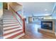 Living room with hardwood floors, a fireplace, and a staircase leading to the second floor at 5449 Manatee Point Dr, New Port Richey, FL 34652