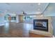 Spacious living room featuring hardwood floors, recessed lighting, a ceiling fan, and a modern fireplace at 5449 Manatee Point Dr, New Port Richey, FL 34652
