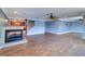 Large living room with hardwood floors, recessed lighting, a modern fireplace, and views of the kitchen at 5449 Manatee Point Dr, New Port Richey, FL 34652