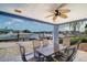 Outdoor patio with seating, a ceiling fan, and picturesque views of the waterfront at 5449 Manatee Point Dr, New Port Richey, FL 34652