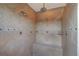 Walk-in shower with multiple shower heads, a built-in seat, and decorative tile at 5449 Manatee Point Dr, New Port Richey, FL 34652