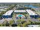 Aerial view of condo buildings with lush landscaping, parking, and a community pool at 5509 Fountain Lake Cir # C209, Bradenton, FL 34207